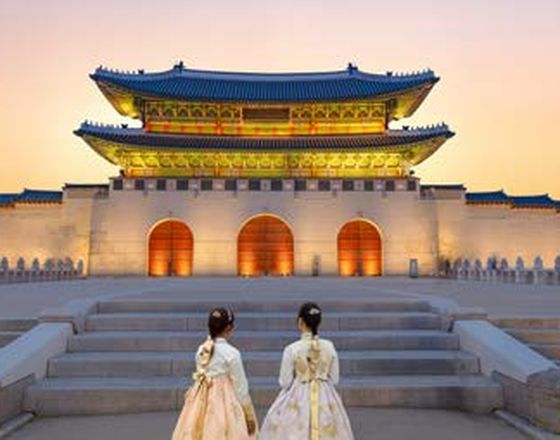 Gyeongbokgung Palace at sunset in hanbok