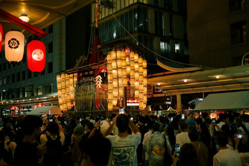Illuminated Gion Matsuri festival float surrounded by crowds in Kyoto
