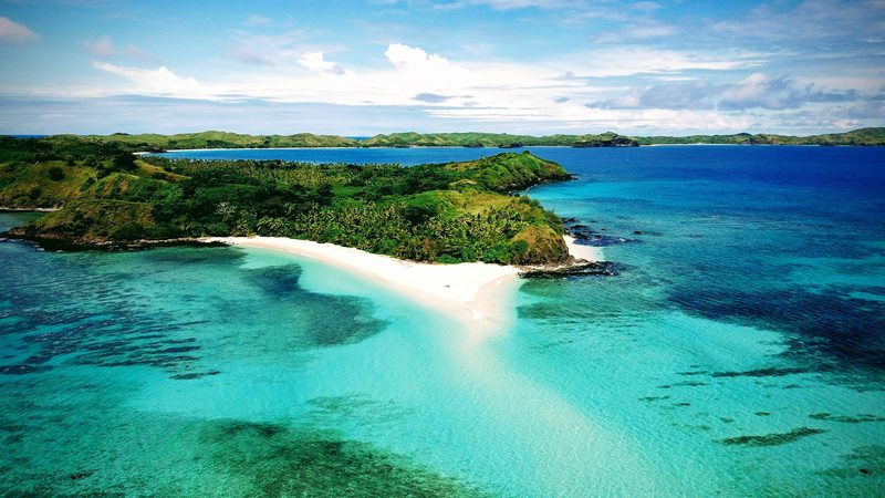Aerial view of a Fiji island with white sand beaches and turquoise water
