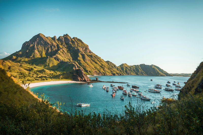 Padar Island viewpoint with boats anchored in turquoise bays