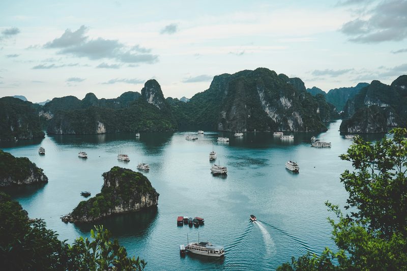 Aerial view of Ha Long Bay limestone karsts with cruise boats below