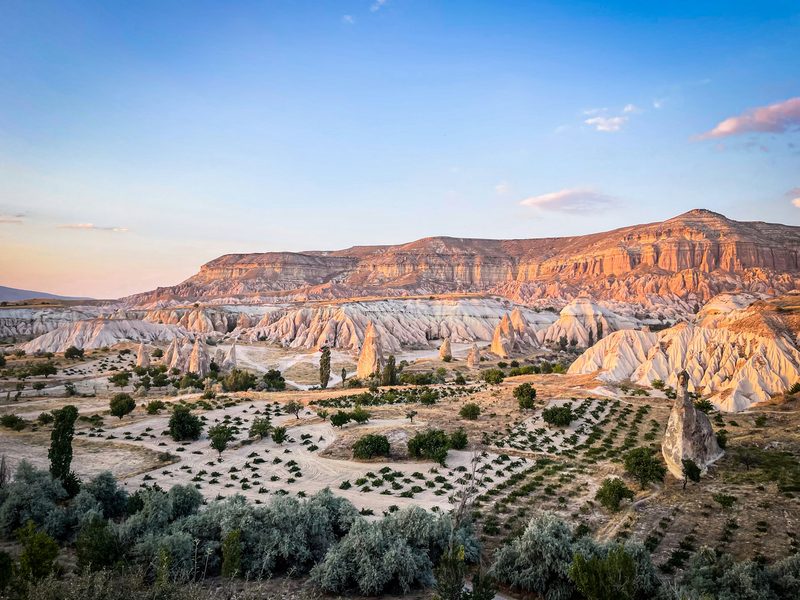 Cappadocia fairy chimneys and Rose Valley glowing at sunset