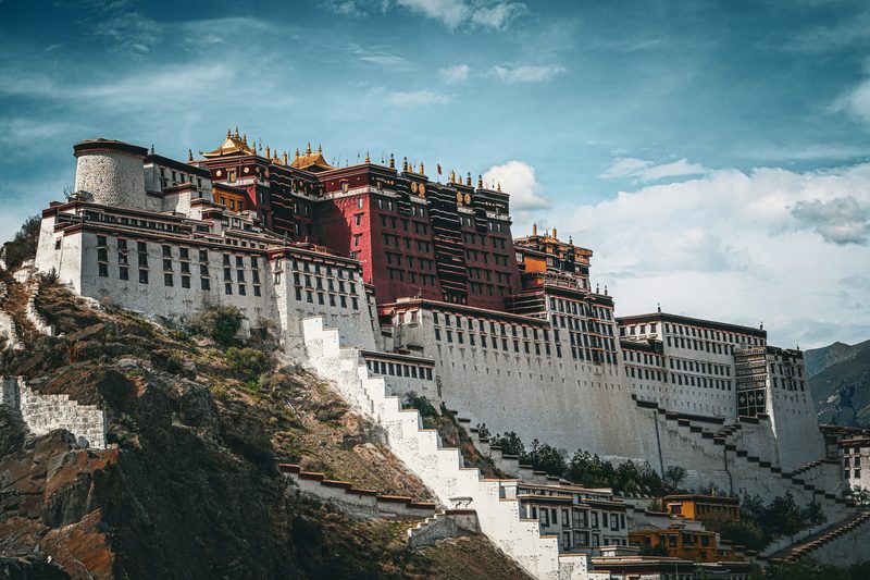 Potala Palace in Lhasa rising against blue sky with gold rooftops