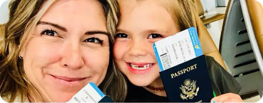 Mom and daughter holding a US passport with airplane tickets. The Mom is Jen Boyd.