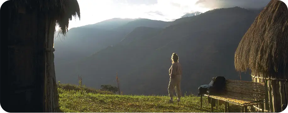 Woman looking off into the distance at a mountain range.