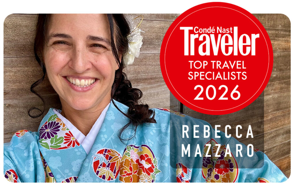 Rebecca Mazzaro smiling in a colorful traditional kimono, with a Condé Nast Traveler “Top Travel Specialists 2026” badge recognizing her as a leading travel advisor.