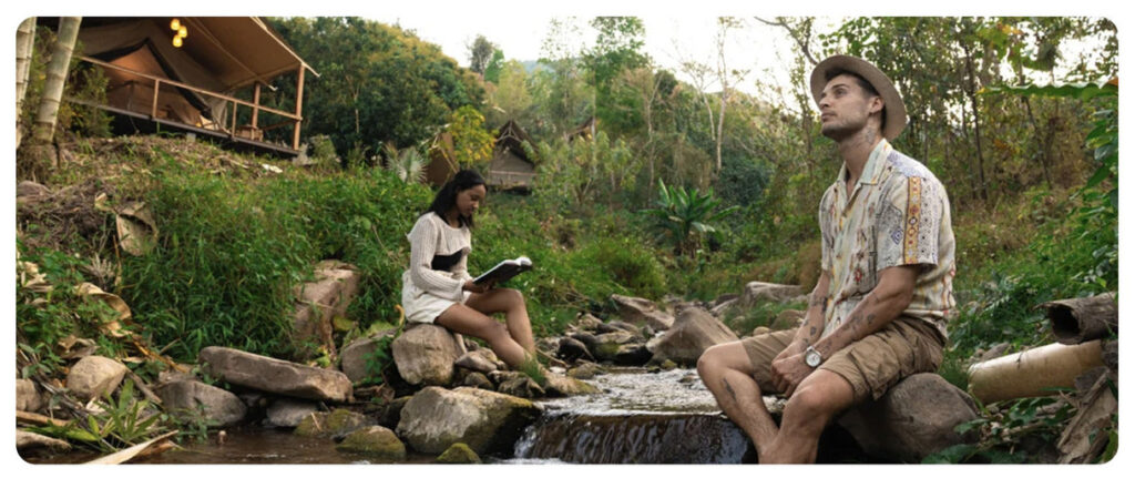 Woman and man by the sides of a small creek